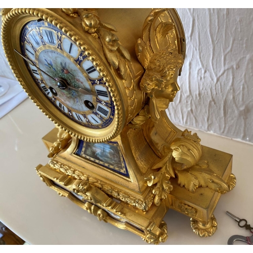 158 - A french ormolu mantel clock surmounted by a paris porcelain urn with acorn finial and acanthus leaf... 