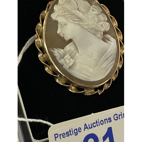 21 - Large 9ct gold cameo brooch with scrolled edging and in very good condition. Total weight is 11.2g a... 