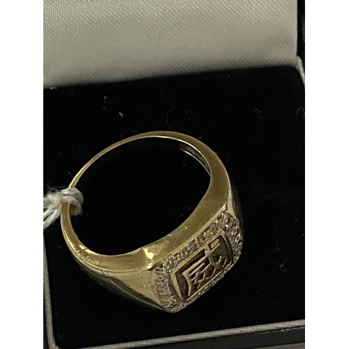 5 - 9ct gold and diamond ring with asian lettering design size S and a half and weighs 6.3g