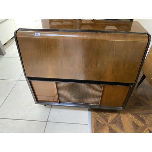 69 - Mid century radiogram with record storage, drop down front, garrard deck. Measures approx 39