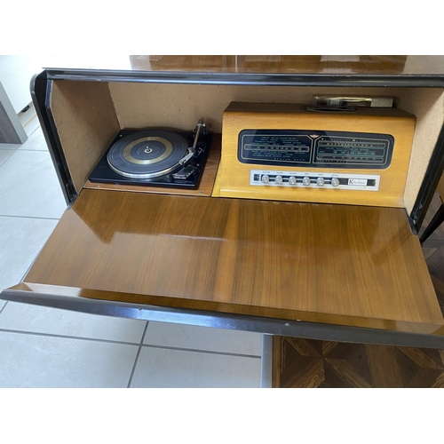 69 - Mid century radiogram with record storage, drop down front, garrard deck. Measures approx 39