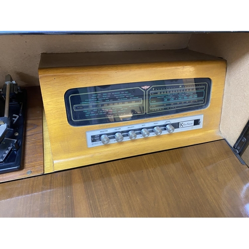 69 - Mid century radiogram with record storage, drop down front, garrard deck. Measures approx 39