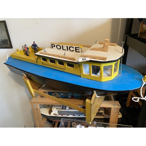 84 - MOTORIZED WOODEN CONSTRUCTION POLICE BOAT LENGTH 83CM WIDTH 30CM