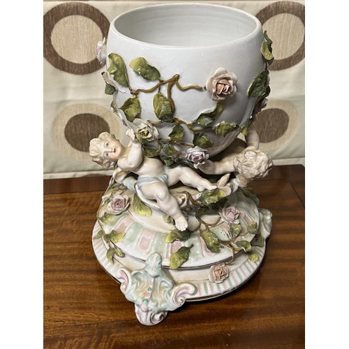 165 - EARLY CHERUB VASE/CENTRE PIECE BOWL WHICH HAS 3 CHERUBS HOLDING THE BOWL VERALL GOOD CONDITION AS SE... 