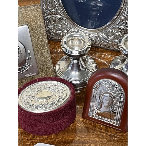 96 - ASST SILVER LOT TO INCLUDE LARGE PICTURE FRAME VARIOUS RELIGIOUS ITEMS, 2 WEIGHTED CANDLE STICKS AND... 