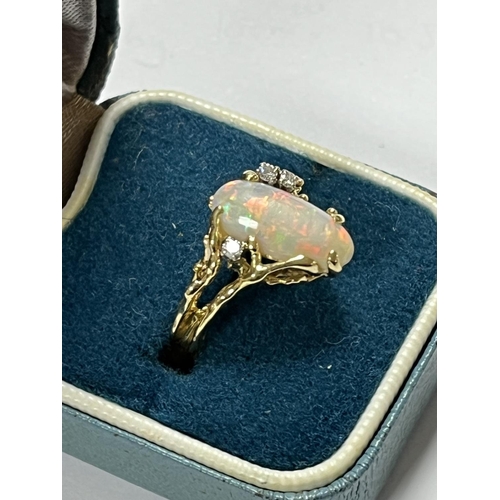 98 - 18CT GOLD OPAL RING WITH 3 SMALL DIAMONDS LOTS OF FIRE AND UNUSUAL DESIGN WEIGHS TOTAL WEIGHT OF 5.7... 