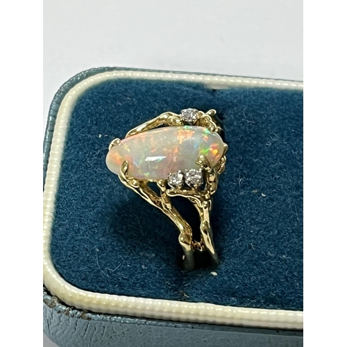 98 - 18CT GOLD OPAL RING WITH 3 SMALL DIAMONDS LOTS OF FIRE AND UNUSUAL DESIGN WEIGHS TOTAL WEIGHT OF 5.7... 