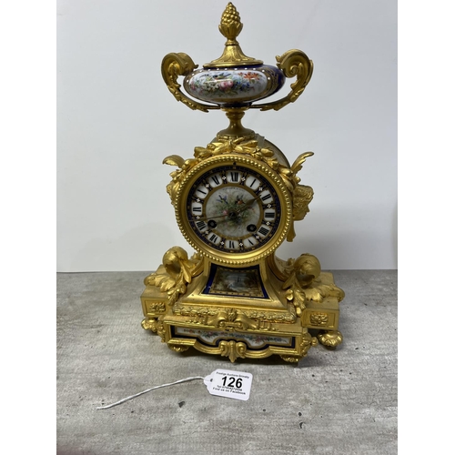 126 - A FRENCH ORMOLU CLOCK SURMOUNTED BY A PARIS PORCELAIN URN WITH ACORN FINIAL AND ACANTHUS LEAF SCROLL... 