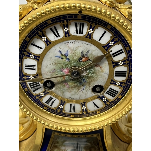 126 - A FRENCH ORMOLU CLOCK SURMOUNTED BY A PARIS PORCELAIN URN WITH ACORN FINIAL AND ACANTHUS LEAF SCROLL... 