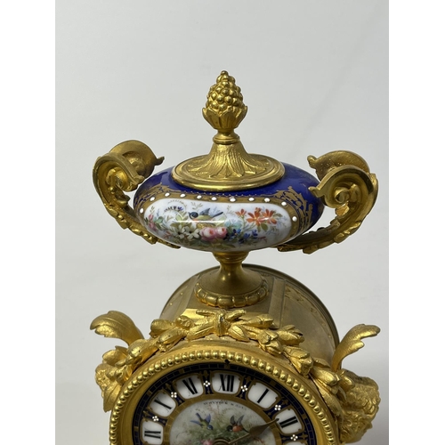 126 - A FRENCH ORMOLU CLOCK SURMOUNTED BY A PARIS PORCELAIN URN WITH ACORN FINIAL AND ACANTHUS LEAF SCROLL... 