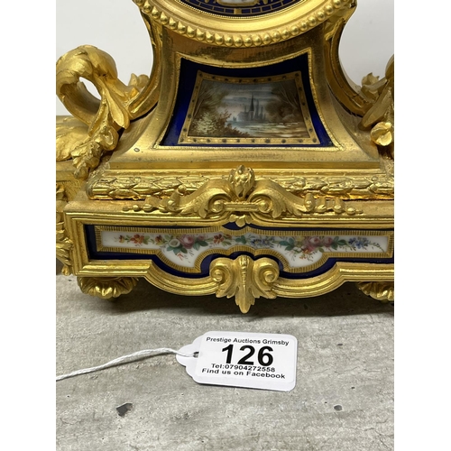 126 - A FRENCH ORMOLU CLOCK SURMOUNTED BY A PARIS PORCELAIN URN WITH ACORN FINIAL AND ACANTHUS LEAF SCROLL... 