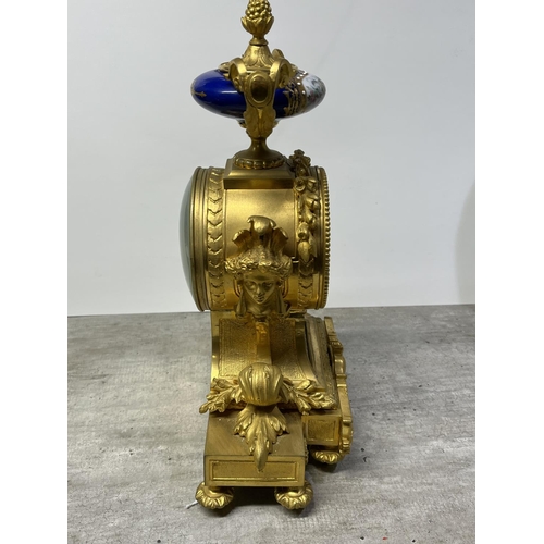 126 - A FRENCH ORMOLU CLOCK SURMOUNTED BY A PARIS PORCELAIN URN WITH ACORN FINIAL AND ACANTHUS LEAF SCROLL... 