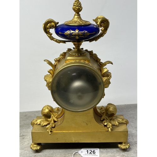 126 - A FRENCH ORMOLU CLOCK SURMOUNTED BY A PARIS PORCELAIN URN WITH ACORN FINIAL AND ACANTHUS LEAF SCROLL... 