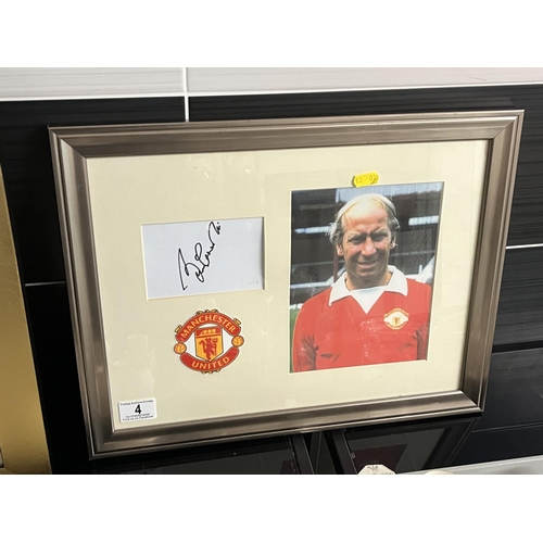 4 - SIGNED BOBBY CHARLTON PICTURE FRAMED WITH A C.O.A MEASURES 46CM WIDE 36CM TALL