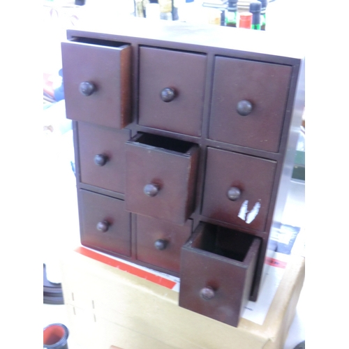 279 - A miniature chest with nine drawers