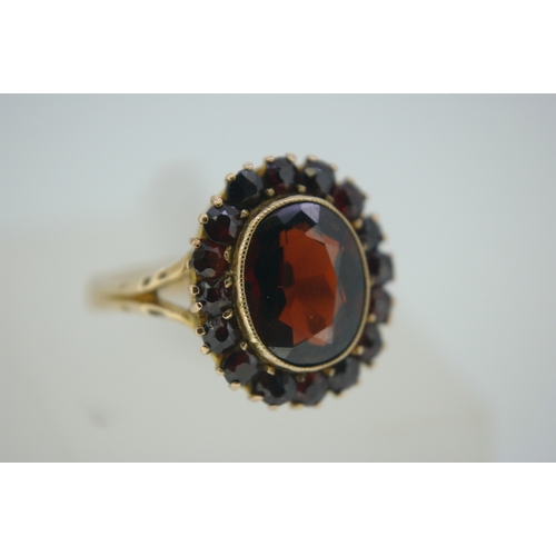 317 - 9 ct gold oval garnet cluster ring, size N