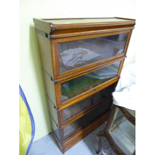 185 - Four section modular oak bookcase with glazed swing up and slide doors by The Globe Wernick Co. Ltd