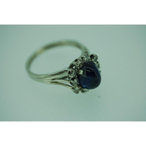 249 - Unusual French cabochon sapphire and diamond ring set in 18ct white gold with diamond surround