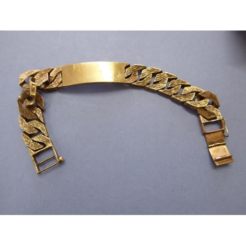 94 - 9ct gold gent's identity bracelet with a bark finish - wt. 72.8g (cased)