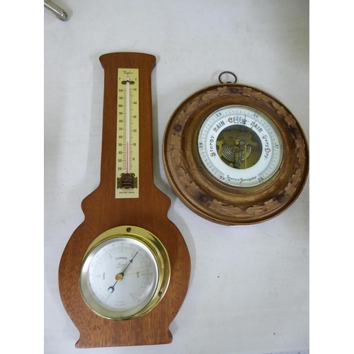 135 - A carved Aneroid Barometer with another barometer/thermometer