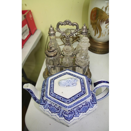 165 - Blue and white oriental teapot with six bottle cruet with some silver topped bottles