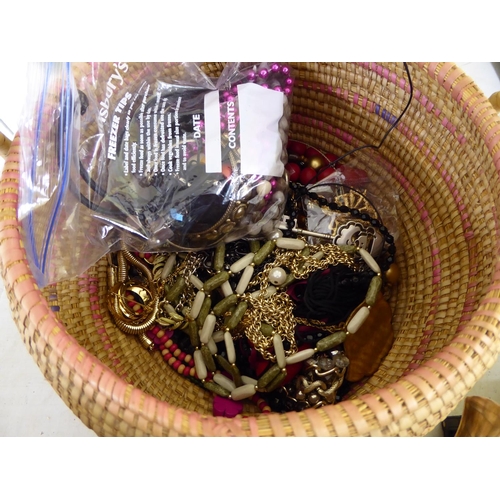 157 - A basket of assorted costume jewellery