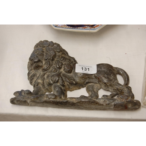 131 - An 18th/19thC lead lion door stop - length 9 ins approx.