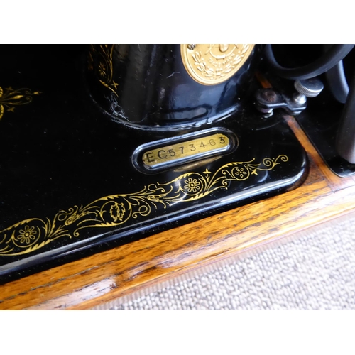 328 - A sewing machine, a typewriter and two brief cases