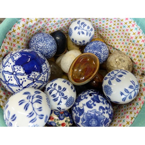 64 - A bag of polished stone eggs with blue and white pottery balls plus a pair of onyx book ends