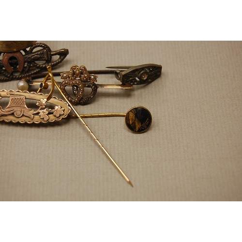 198 - A collection of gold brooches, stick pins etc.