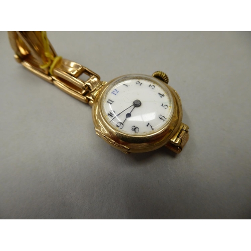 68 - A 9 ct gold  Ladies wrist watch with sprung 9 ct gold strap