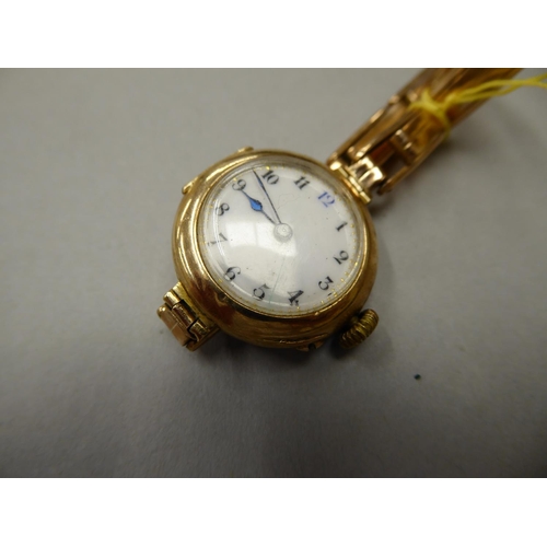 68 - A 9 ct gold  Ladies wrist watch with sprung 9 ct gold strap