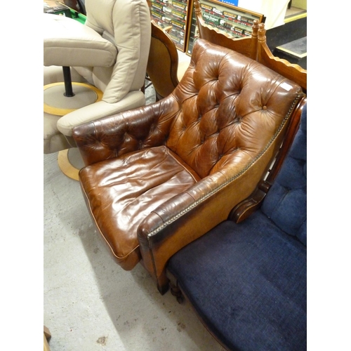 304 - Brown leather button upholstered armchair with studwork to arms