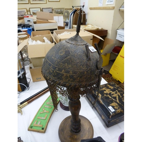 288 - Persian etched metal helmet with chain mail to back on a wooden stand