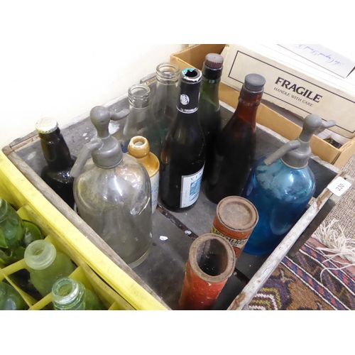 230 - A collection of old soda syphons, Manx bottles etc in a Kelly's wooden crate