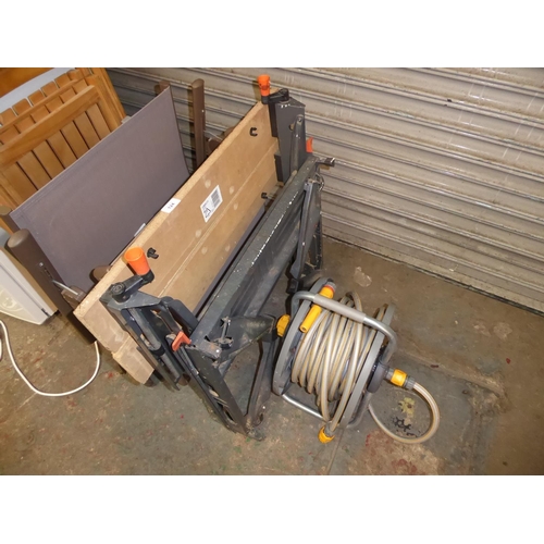 124 - Black & Decker folding work bench plus a hose on a reel