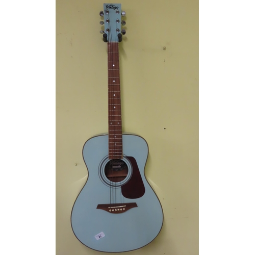 83 - A vintage pale blue coloured acoustic guitar