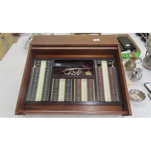 272 - Opticians eye testing lens set held in a wooden cabinet