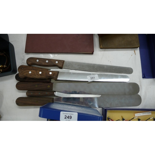 251 - A collection of chef's knives and spatulars