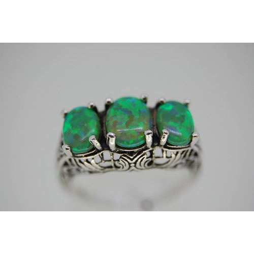 422 - A silver ring with three good quality opals size L/M