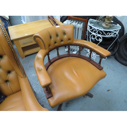 15 - Orange leather upholstered Captain's chair on castors with lion paw feet