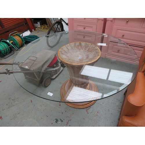 17 - Gilt wood pedestal supporting a circular bevel edged glass top, 50 inch diameter