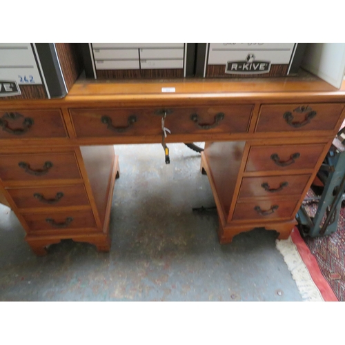 82 - Eight drawer desk with brown leather insert and swing handles