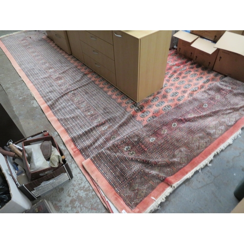 89 - Large wool carpet in with underlay in mostly black and pink wools, approx size 148 x 194 inches