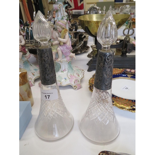 17 - A pair of quality cut glass decanters with chased silver collars - ht. 9.5 ins