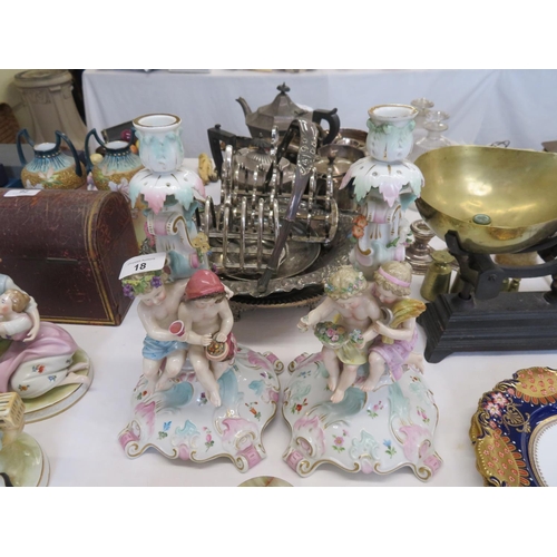 18 - Pair of continental pottery candle sticks with children eating and playing in relief - ht. 13 ins