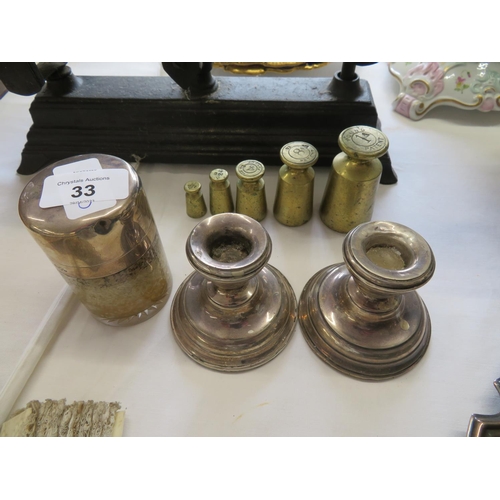 33 - A pair of loaded silver candle holders plus a silver topped jar