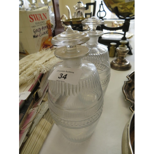 34 - Pair of early 19thC cut glass decanters - ht. 8 ins approx.