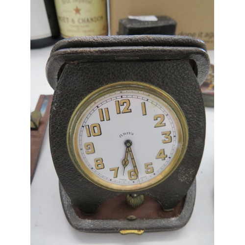 56 - A leather cased eight day travel clock (ticking)