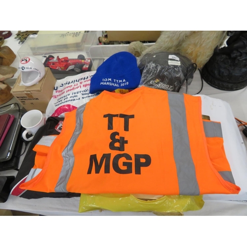 291 - Large collection of TT and MGP items - Marshalls tabbard, hats, magazines, bag etc